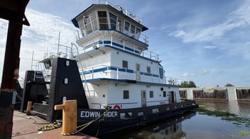The M/V Edwin Rider pushboat docked at a shipyard.