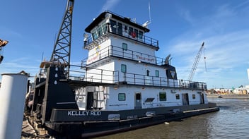 The M/V Kelley Reid pushboat docked at a shipyard, viewed from the waterline