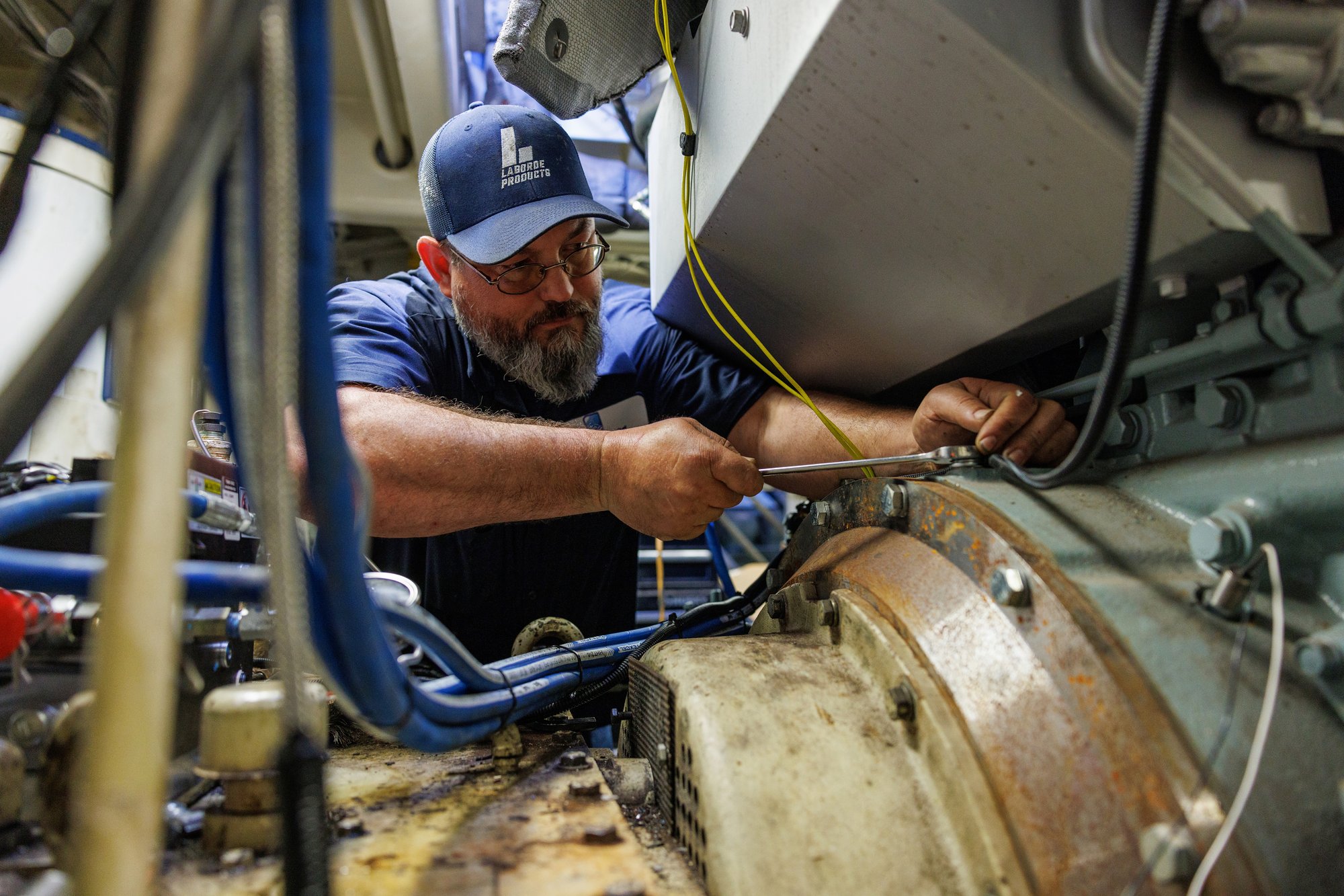 Laborde products employee providing marine engine care on a Mitsubishi Marine Engine