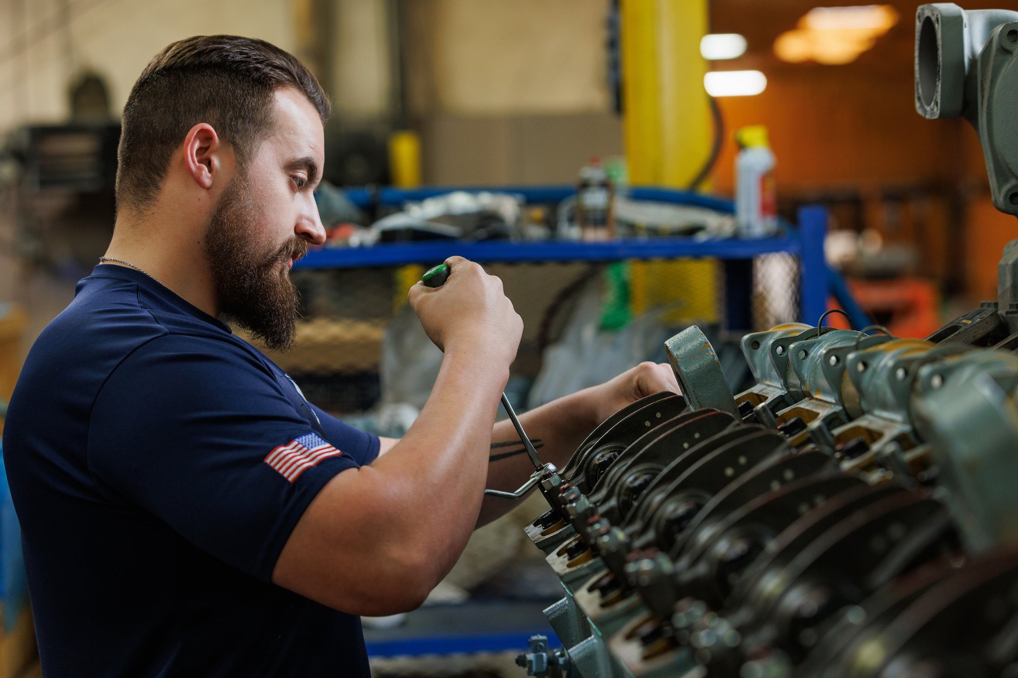 Laborde Products Technician servicing a Mitsubishi marine diesel engine, adjusting valve components to support engine longevity and optimal performance.