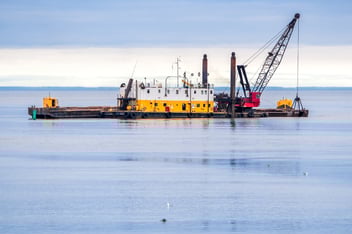 Commercial dredging operation in industrial harbor